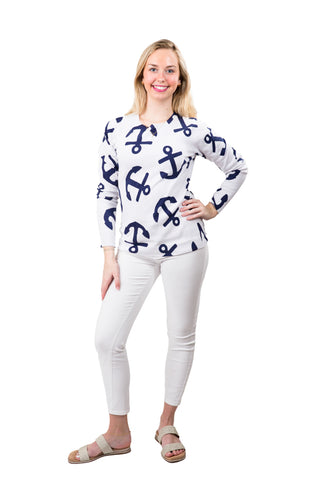 Woman wearing a white sweater with blue anchor patterns on a white background