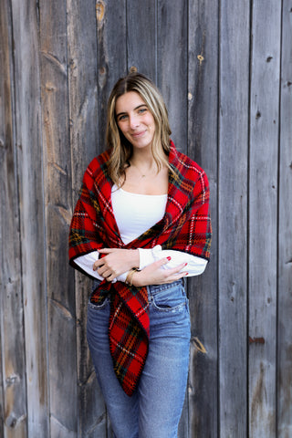 Woman wearing Claire Plaid Wrap in red plaid with tailored V-back design.