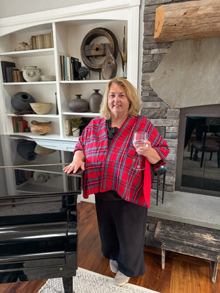 Woman in a red tartan plaid keyhole wrap draped over shoulders.