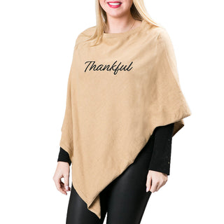 Thankful in black embroidered script lettering on tan knit poncho shawl