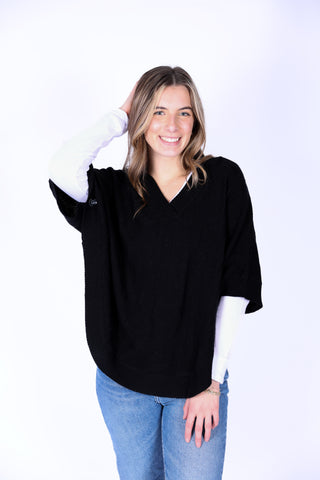 Black McKenna Capelet in cable knit, perfect for layering in fall.