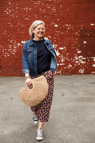 woman holding Natural rounded straw handbag