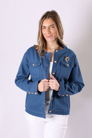 Blue denim jacket paired with a usa bow brooch