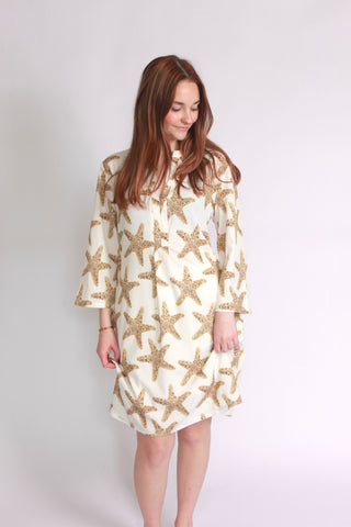 Woman wearing a sequins starfish patterned bell sleeve dress