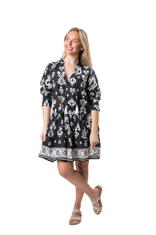 Black and white paisley pattern tiered long sleeve tunic dress with a split neck and tassel ties