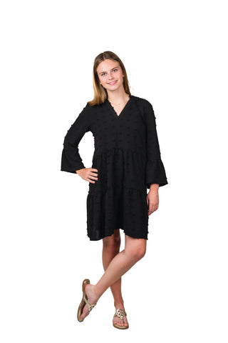 Women wearing black swing dress with swiss dots