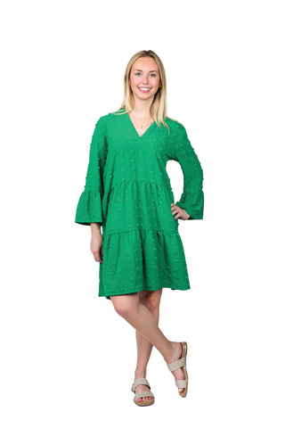 Women wearing green swing dress with swiss dots