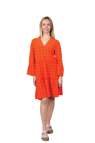 Women wearing orange swing dress with swiss dots