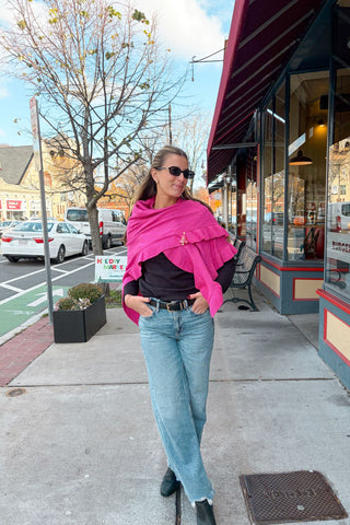 Woman wearing a pink scarf on a city street