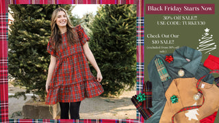 Woman in a red plaid dress standing outdoors with Christmas decorations and sale information on the side.