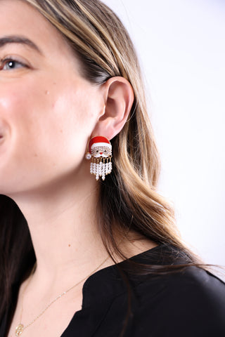 Woman wearing santa earrings