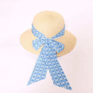 Brigitte Twillie Ribbon Hat with a blue geometric print ribbon tied in a bow.
