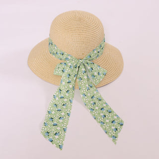 Brigitte Twillie Ribbon Hat featuring a green lattice ribbon with blue hydrangea accents.