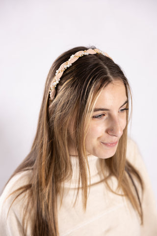 model wearing light pink headbands with pearl and gold accents 