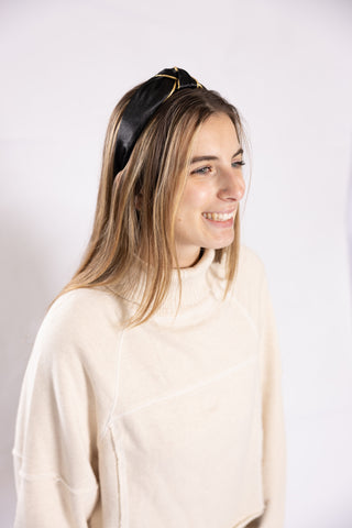 model wearing Black knotted headband with gold trim