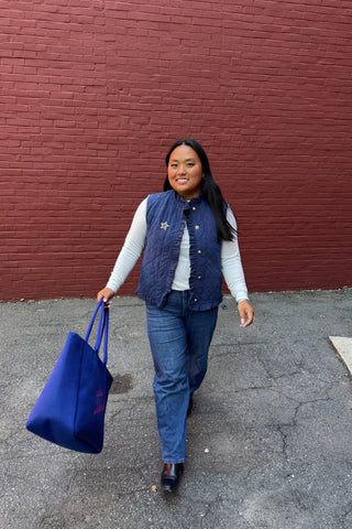 Woman wearing navy corduroy vest
