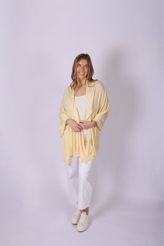 Woman wearing Ari Solid Bamboo Shawl in a butter yellow 