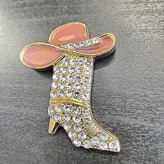 Brown enamel cowgirl hat on gold boot-shaped brooch with clear rhinestones