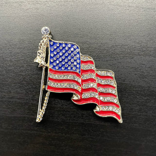 Gold American flag brooch with red and blue enamel and clear rhinestones