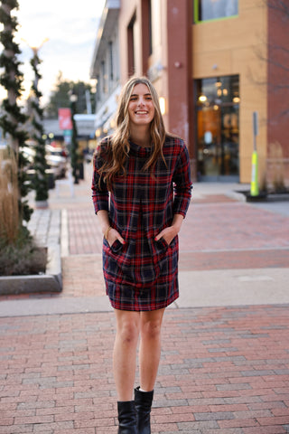 Woman wearing a plaid dress on a city street