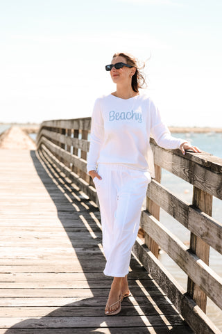 women wearing white pants and white sweater