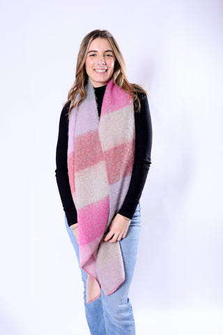 Woman modeling the Anne Scarf in wide pink and beige stripes, cozy and chic for fall.