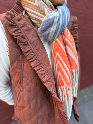 close up of brown, light blue, orange and cream chevron scarf with fringe