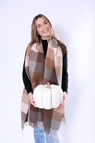 Phoebe Scarf in warm brown plaid tones styled with fall outfit, holding white pumpkin.
