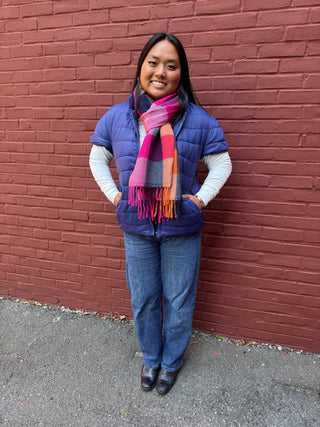 woman wearing navy puffer vest and a scarf