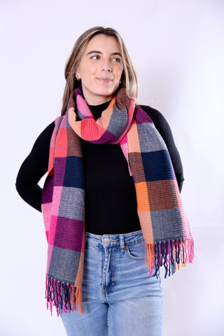 Phoebe Scarf in bold orange and pink plaid with ribbed texture.