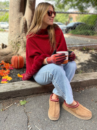 woman wearing orange plaid gloves