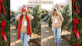 Woman wearing a beige sweater with a white tree design in a Christmas tree lot.