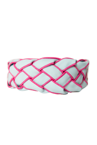 Woven headband with pink and white pattern on a white background