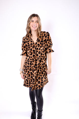 Woman wearing a leopard print dress with short bubble sleeves