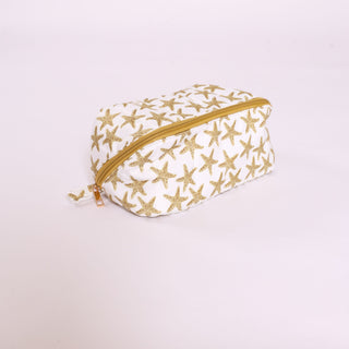 Small pouch with gold starfish pattern on a white background