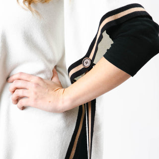 close up of amelia ruana in cream with black and camel stripes on sides