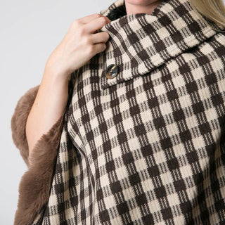 close up of collar with button of taupe and brown check plaid poncho with brown faux fur trim