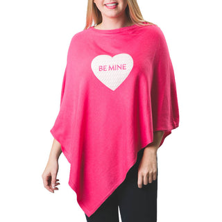 White cable knit heart with BE MINE in pink embroidered letters on medium pink knit poncho shawl