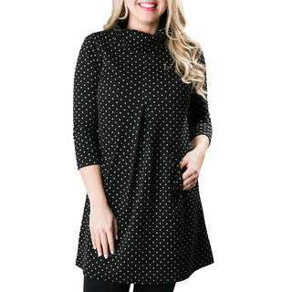 Black with white polka dot print jacquard knit tunic dress with three quarter sleeves, turtleneck and front pleat